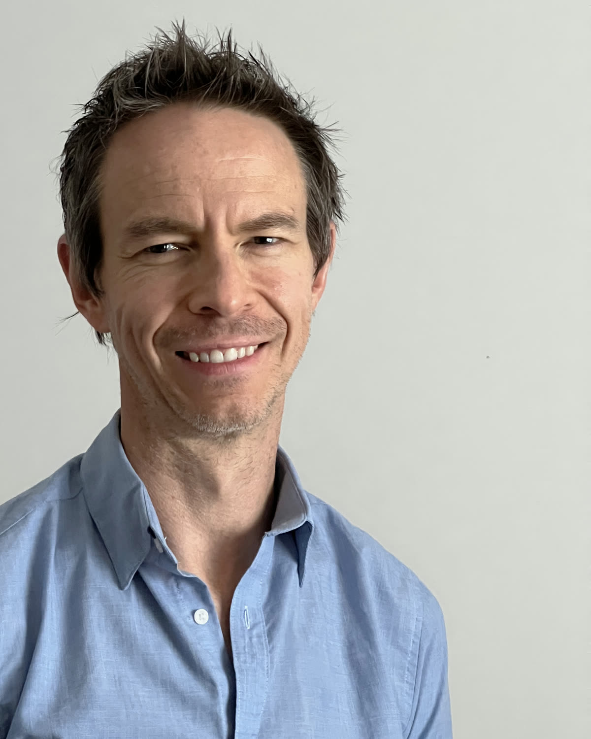 Jeff Appelhans smiling in a blue shirt.